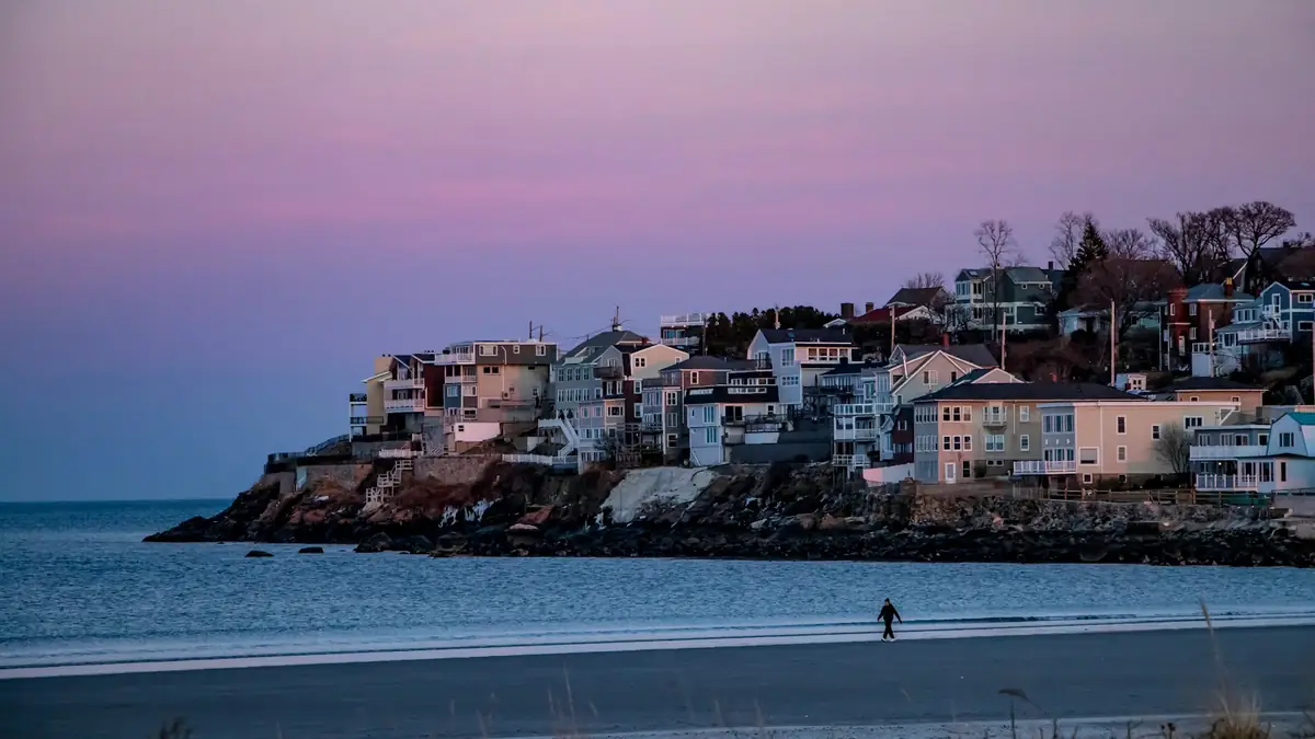 Houses stacked on a hill above the beach at dusk - Leak Detection in Beachmont